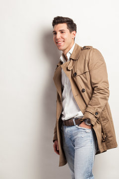 young attractive man in a trench rain coat
