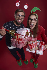 Pile of gifts held by couple.