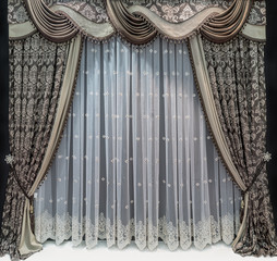 The luxurious design of the windows and walls in a classic style. A brown curtains with floral...