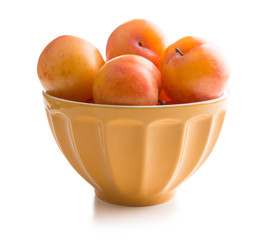 Ripe yellow plums in bowl.