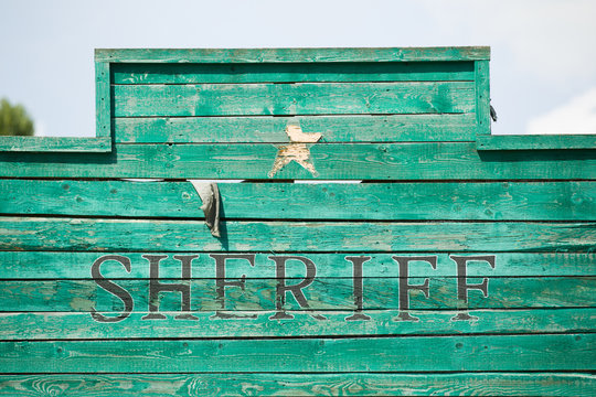 Old, western style green wooden Sheriff sign