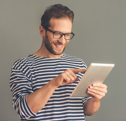 Handsome stylish man with gadget