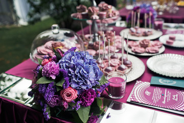 Gorgeous bouquet stands on the violet sweet bar