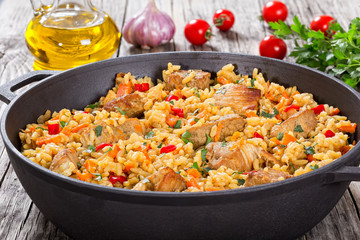 Homemade prepared paella with meat, pepper, vegetables and spice