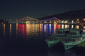 beautiful bridge over the river at night in the background a salute. High ISO