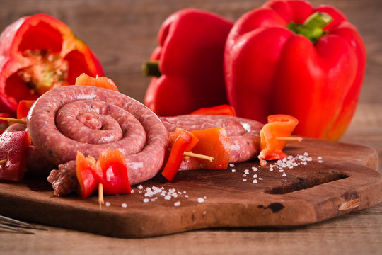 Raw sausage on wooden table.