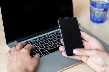 Unrecognizable man using a modern portable computer on an white table
