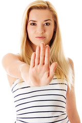Young woman making stop sign on white background.