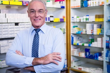 Pharmacist standing with arms crossed
