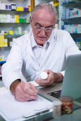 Fototapeta na wymiar Pharmacist writing prescriptions for medicines