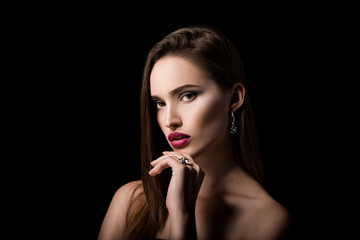 Beauty portrait of girl with jewelry on black background