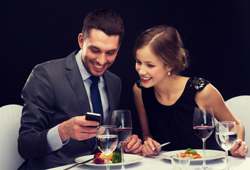 smiling couple eating main course at restaurant