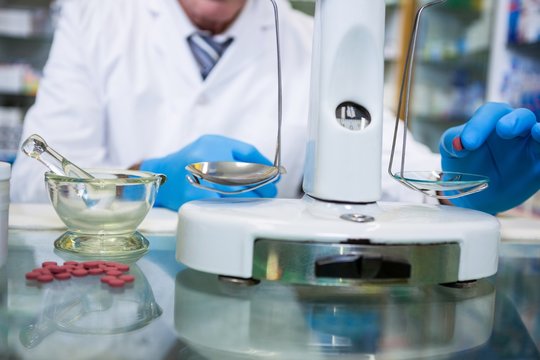 Pharmacist Measuring Tablets With Pharmacy Scale