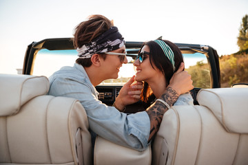 Couple kissing in cabriolet in summer