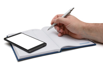 smartphone screen and the hand makes an entry in notebook