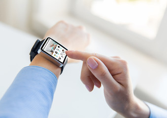 close up of hands with online shop on smart watch