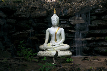 waterfall in mountains  behind Buddha,