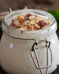 Greek yogurt with cereal on a wooden table