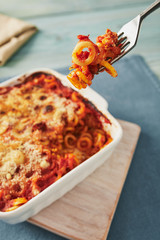 Baked anelletti pasta with mince, sauce and mozzarella. Typical sicilian dish