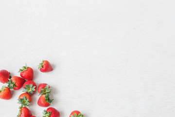 Fresh strawberry on white wooden background.