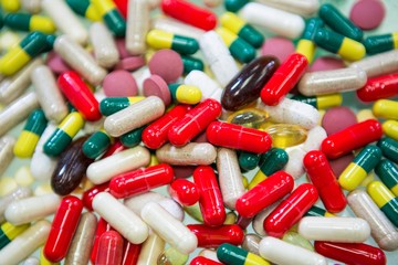 Various capsules and tablets spilled