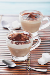 Italian cappuccino in a glass cup with cacao powder