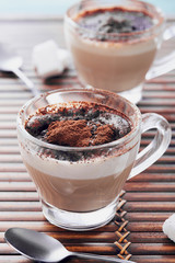 Italian cappuccino in a glass cup with cacao powder