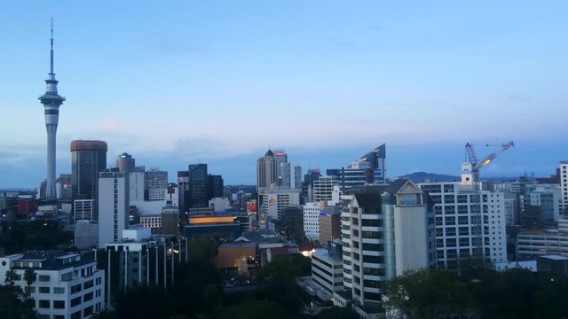 AUCKLAND - SEP 27 2016:Panoramic view of Auckland Sky tower skyline in colors at dusk.Auckland is frequently ranked within the worlds top 10 most liveable cities