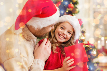 smiling father and daughter opening gift box