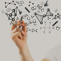Man writing chemical formulas