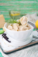 Plate of boiled pelmeni with cheese
