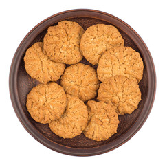 Oatmeal cookies in a brown plate.