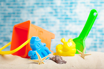 Fototapeta na wymiar Children's toys on sand