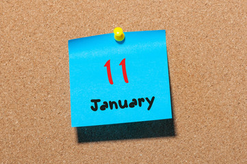 January 11th. Day 11 of month, Calendar on cork notice board. Winter time. Empty space for text