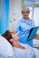 Fototapeta premium Nurse checking patient temperature