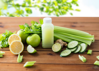 close up of bottle with green juice and vegetables