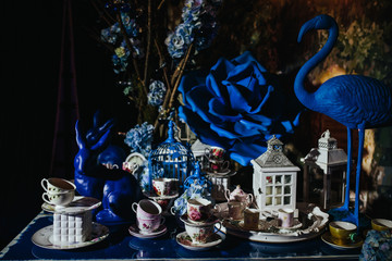 Table decor. A figure of blue flamingo standing on a table full