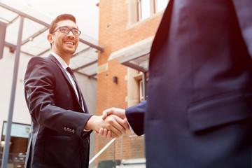 Two businessmen shaking their hands