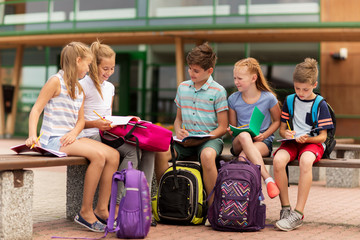 group of happy elementary school students outdoors