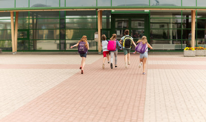 group of happy elementary school students running