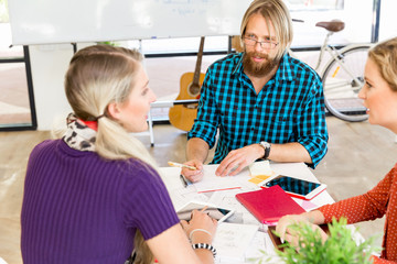 Young office workers discussing