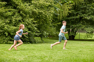 happy kids running and playing game outdoors © Syda Productions
