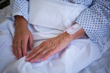 Close-up of patients hand with iv drip 