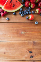 close up of fruits and berries on wooden table