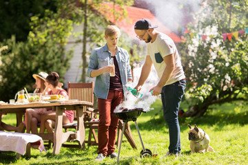 friends making barbecue grill at summer party