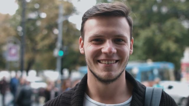 Slow Motion Portrait of happy cute caucasian man smiling in city real people series