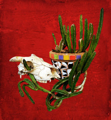 Sheep skull and Mexican mosaic pot plant with cactus on a rustic red wood background. Digitally filtered and textured image