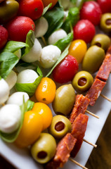 antipasto skewers on a white plate 
