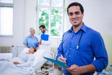 Smiling doctor holding a medical report