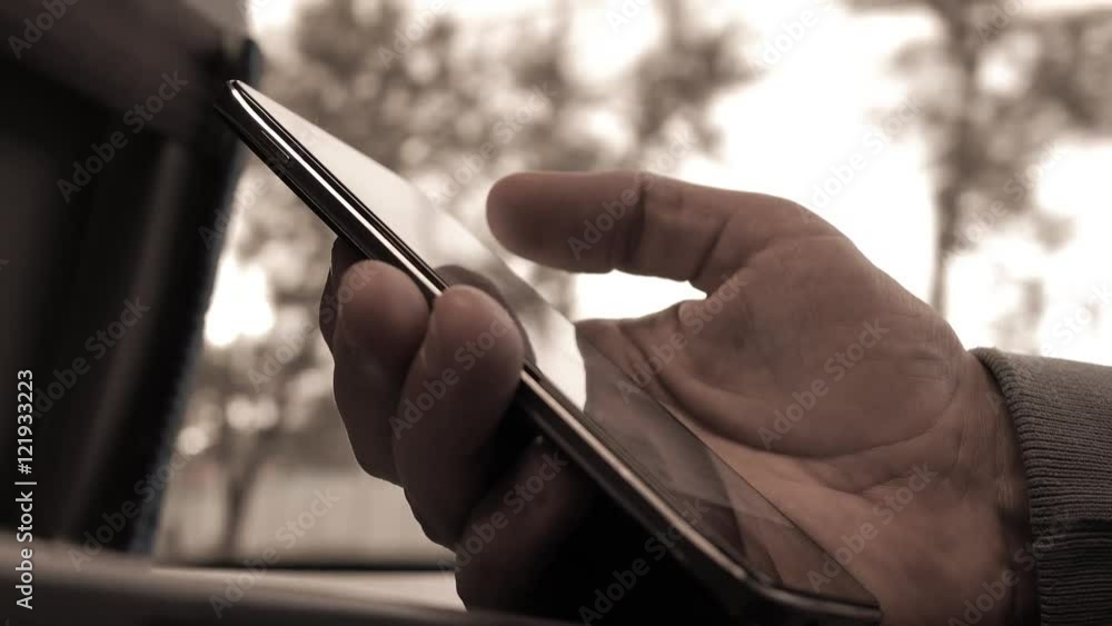 Poster man using his telephone in the train. scrolling on device touchscreen. 4k closeup video